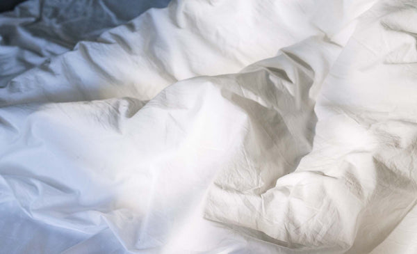 white bedsheets close up in natural light