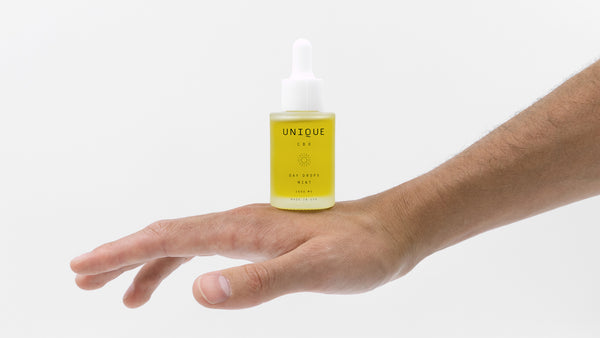 unique CBD bottle on back of hand