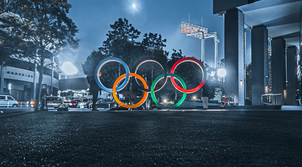 olympic rings monument lit up outdoors at night