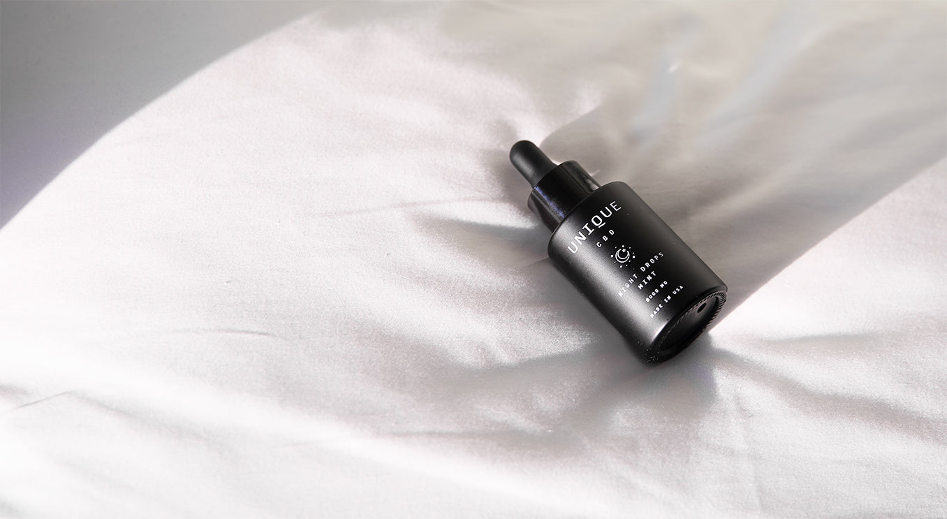 night drops cbd bottle on pillow