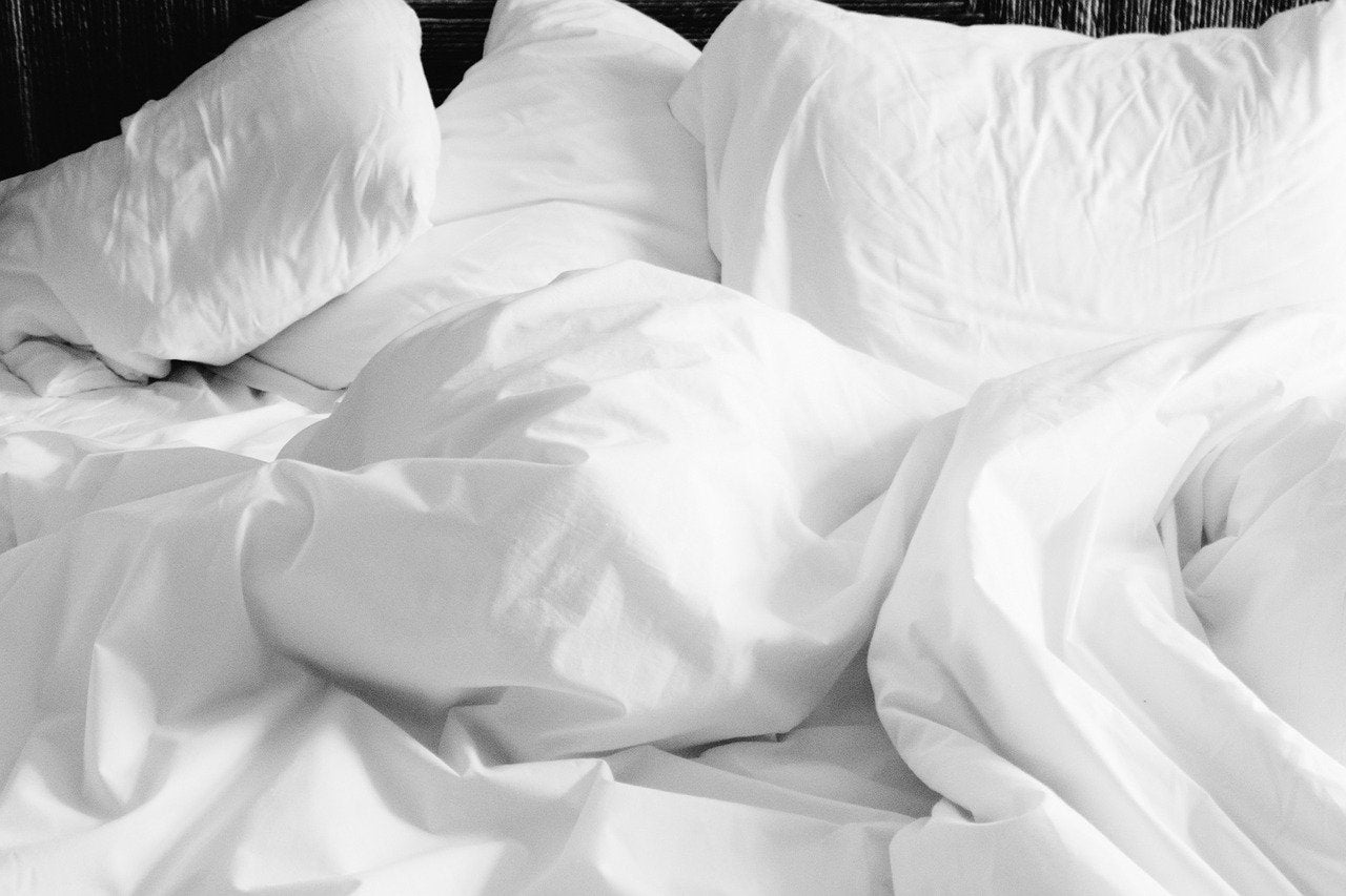 white pillows and bed sheets