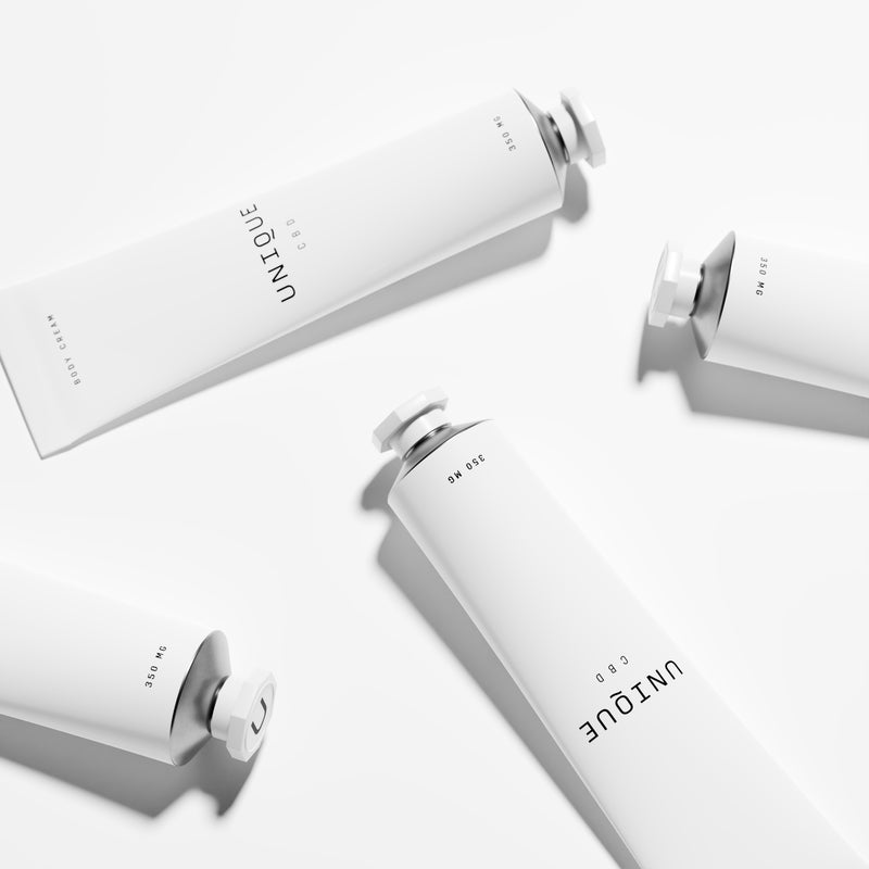 body cream aluminium tubes on white surface