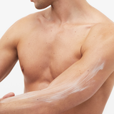 Man rubbing Unique CBD Body cream into arm