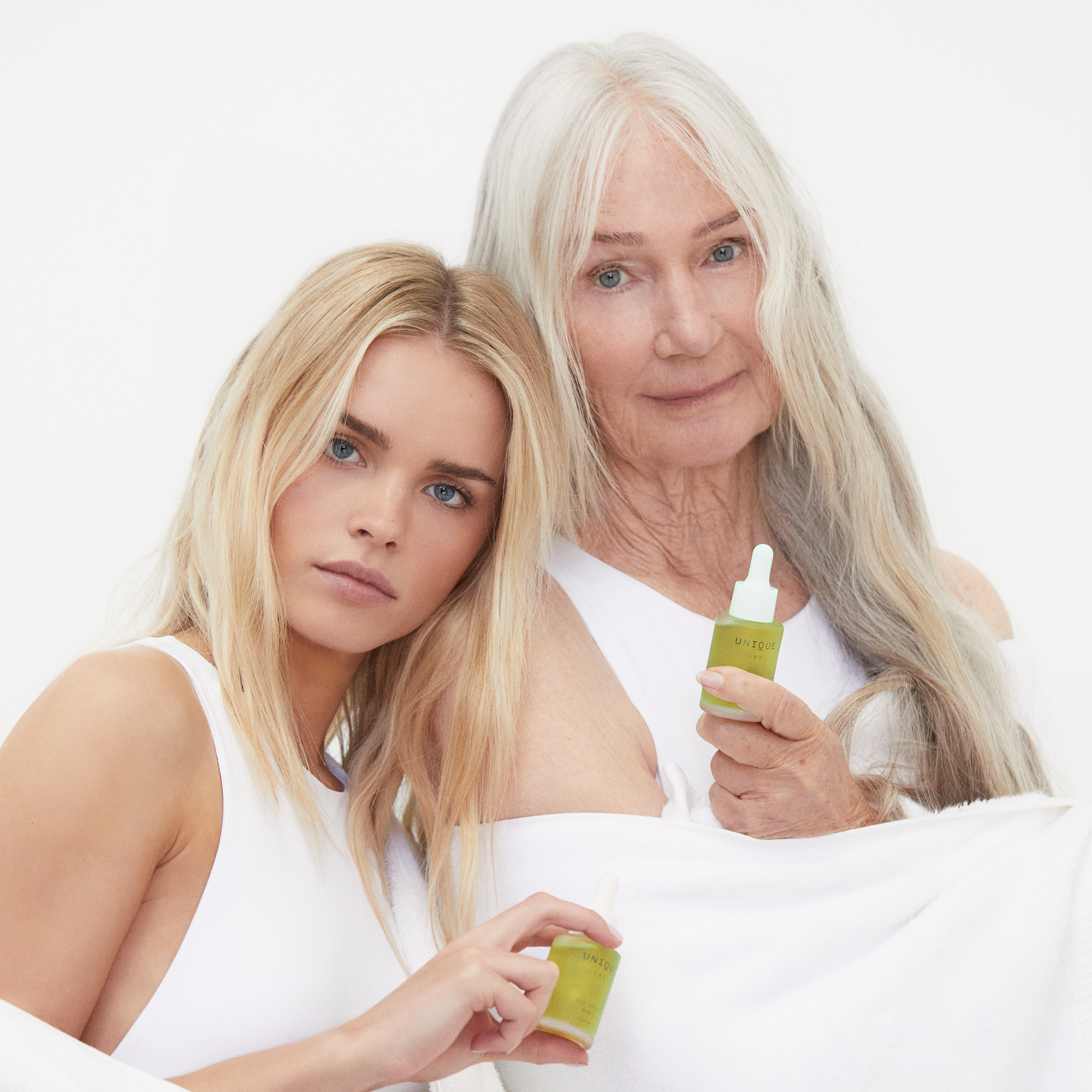 Younger and Older Women holding Unique CBD Day Drops Bottle 30ml